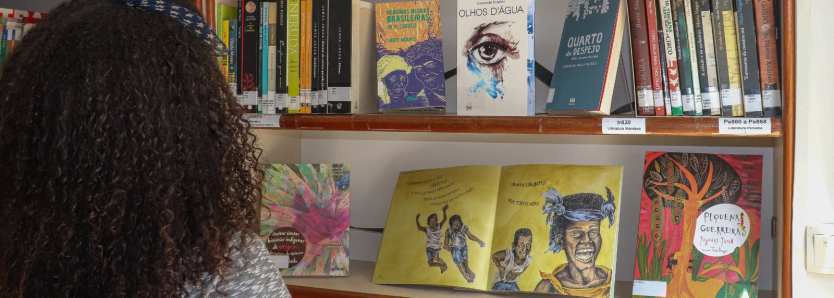 Criança explorando o BiblioSesc RJ durante ação de doação de livros.